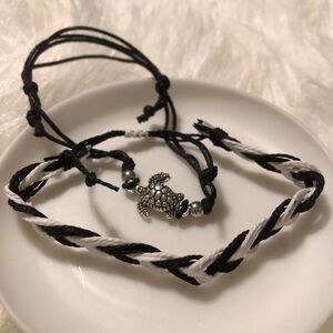 Two adjustable string black/white turtle charm bracelets